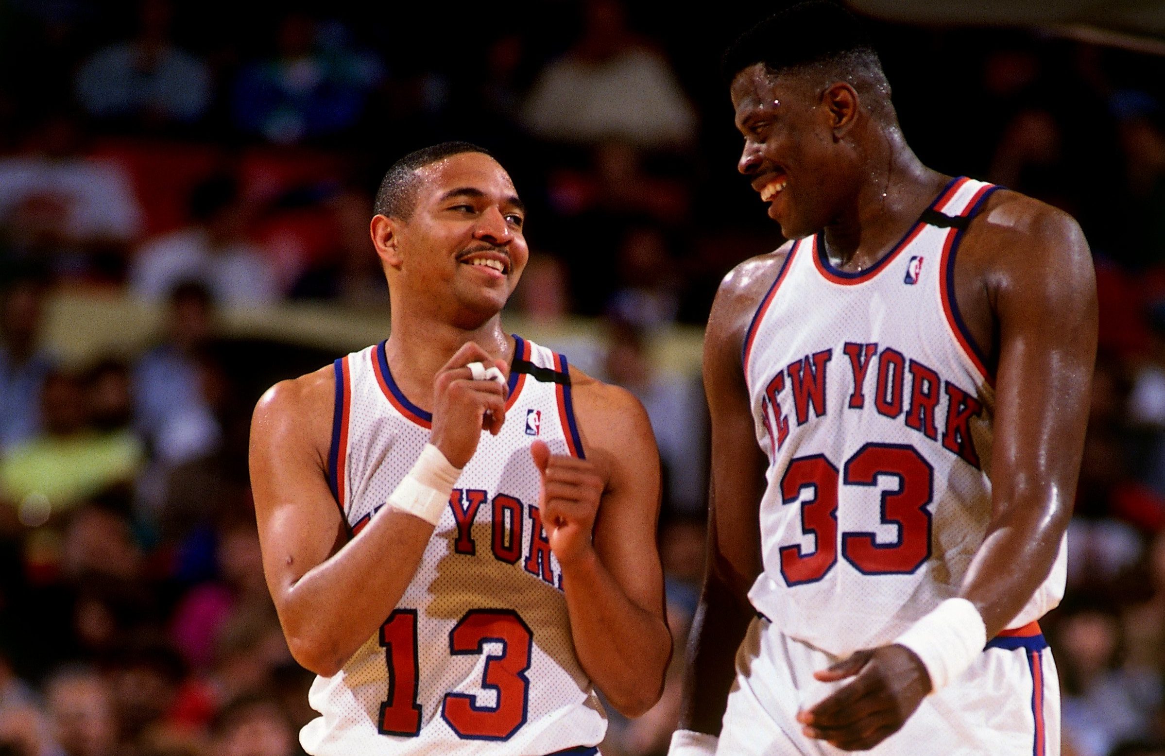 NEW YORK - 1990: Patrick Ewing #33 of the New York Knicks chats with teammate Mark Jackson #13 circa 1990 at Madison Square Garden in New York, New York. NOTE TO USER: User expressly acknowledges that, by downloading and or using this photograph, User is consenting to the terms and conditions of the Getty Images License agreement. Mandatory Copyright Notice: Copyright 1990 NBAE (Photo by Nathaniel S. Butler/NBAE via Getty Images)