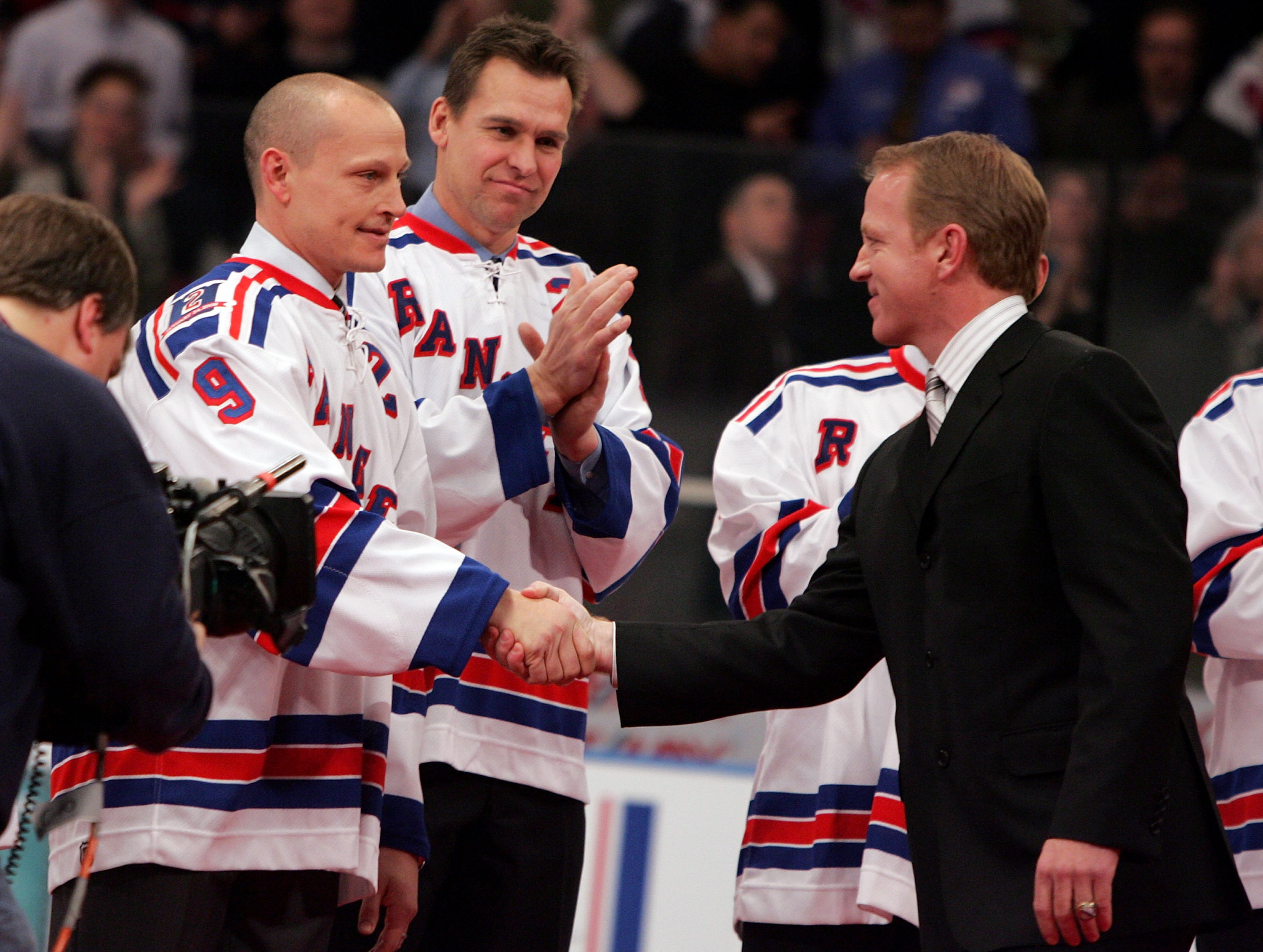 NEW YORK - JANUARY 24: Former New York Ranger Brian Leetch shakes hands with former teammate Adam Graves during his jersey retirment ceremony before the game against the Atlanta Thrashers on January 24, 2008 at Madison Square Garden in New York City.Leetch made a surprise announcement during his speech that the Rangers would retire Graves' number next season.Leetch became the fifth Ranger in history to have his number retired. (Photo by Jim McIsaac/Getty Images)